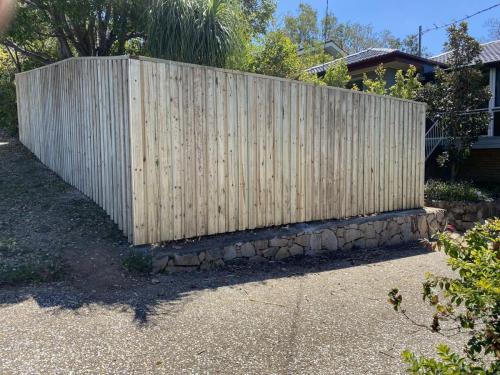 Timber fencing with retaining wall